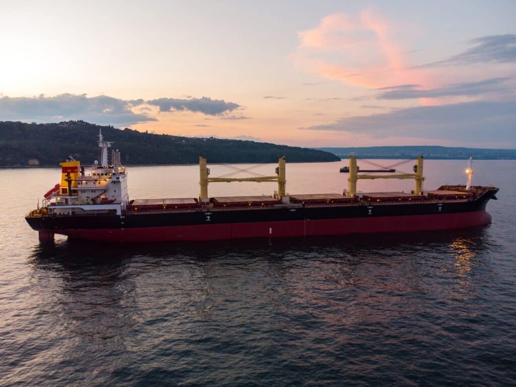 Large general cargo ship tanker bulk carrier, aerial view at night.